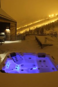 Hot tub in the snow overlooking the ski slopes